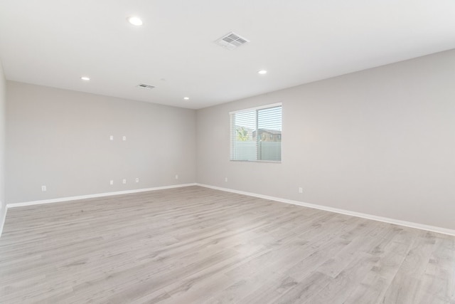 unfurnished room featuring light hardwood / wood-style floors