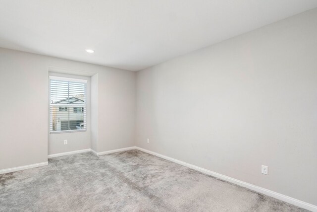 empty room featuring light carpet