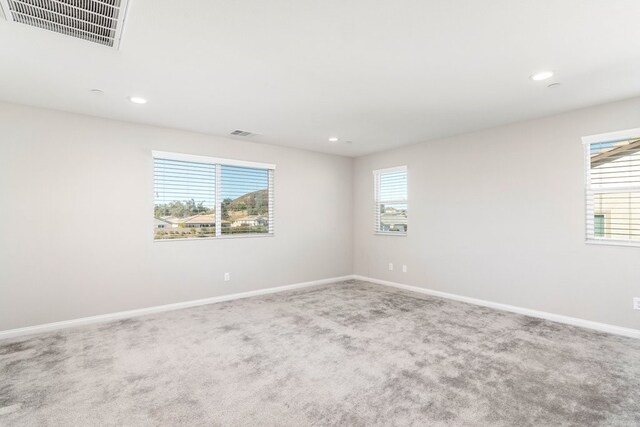 unfurnished room featuring carpet