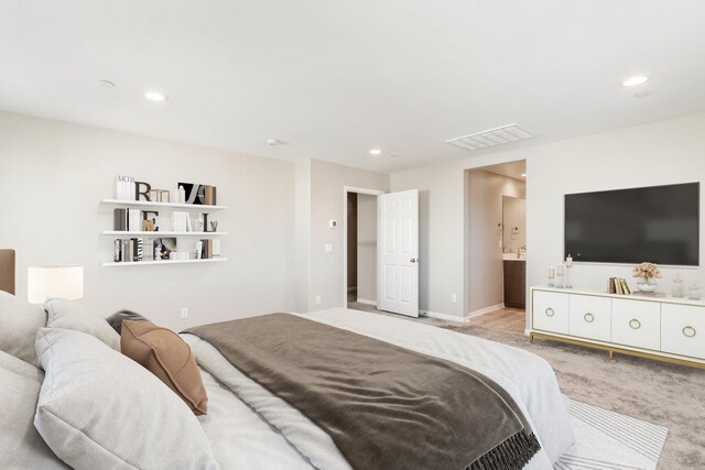 carpeted bedroom featuring ensuite bathroom