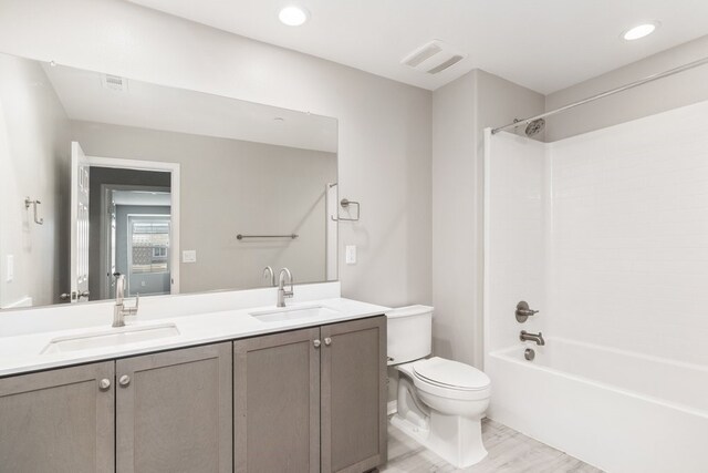 full bathroom with toilet, bathing tub / shower combination, wood-type flooring, and vanity