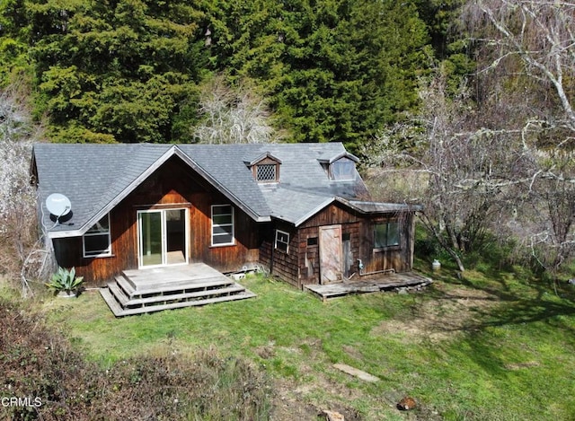 back of house with a lawn and a deck