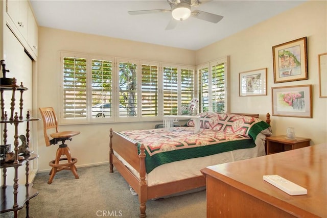 bedroom with ceiling fan and light colored carpet