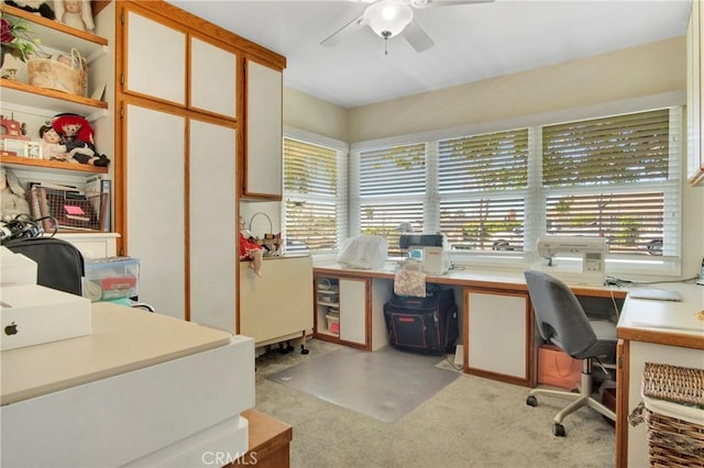 office featuring ceiling fan and light carpet