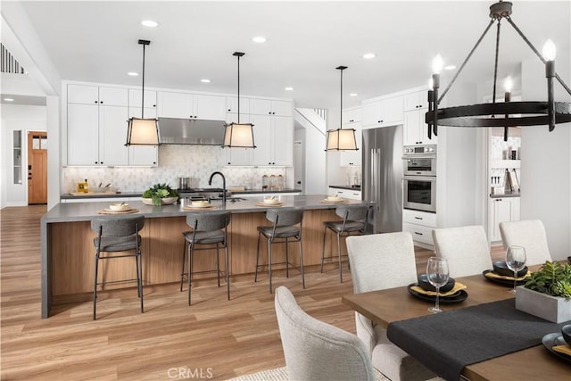 dining space featuring light hardwood / wood-style floors and sink