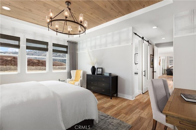 bedroom featuring wood ceiling, a chandelier, a barn door, and light hardwood / wood-style floors