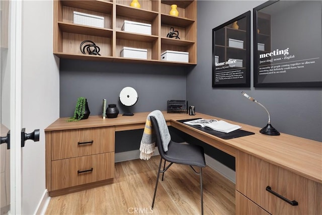 office area featuring built in desk and light wood-type flooring