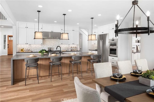 dining space with light hardwood / wood-style floors and sink