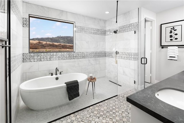 bathroom with tile patterned floors, separate shower and tub, and vanity