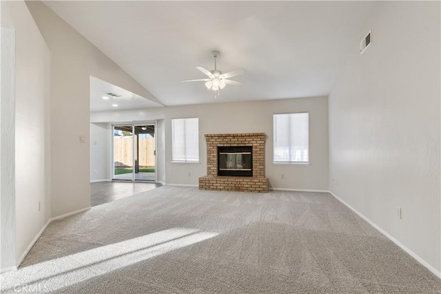 unfurnished living room featuring ceiling fan, light carpet, lofted ceiling, and a fireplace