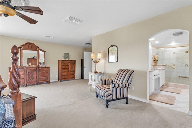 living area with light carpet and ceiling fan