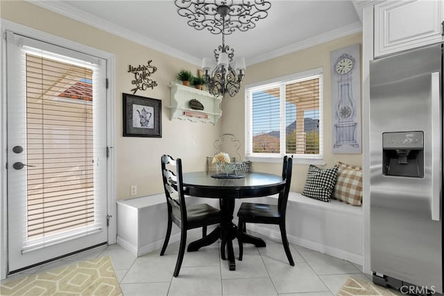 tiled dining area featuring ornamental molding and an inviting chandelier