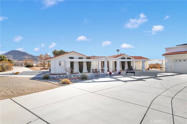 mediterranean / spanish-style home with a garage and a mountain view