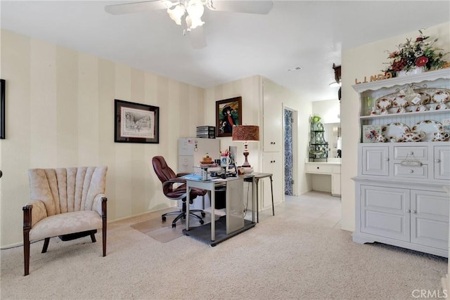 carpeted office featuring ceiling fan