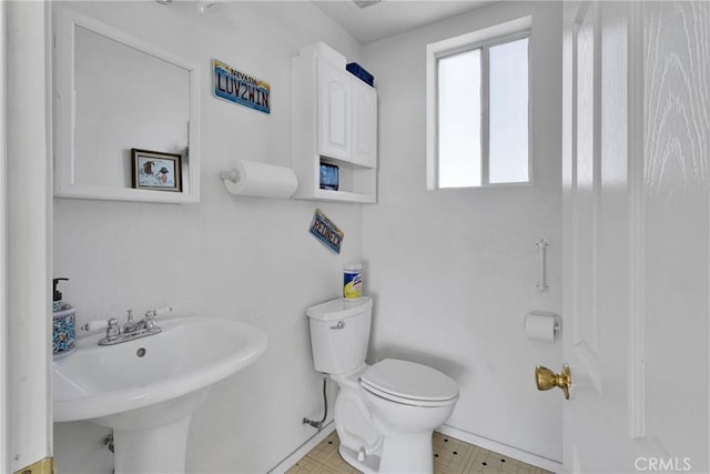 bathroom featuring toilet and sink