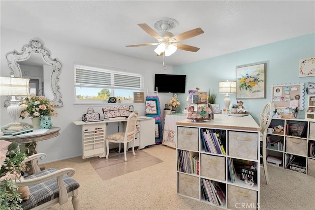 carpeted office space featuring ceiling fan