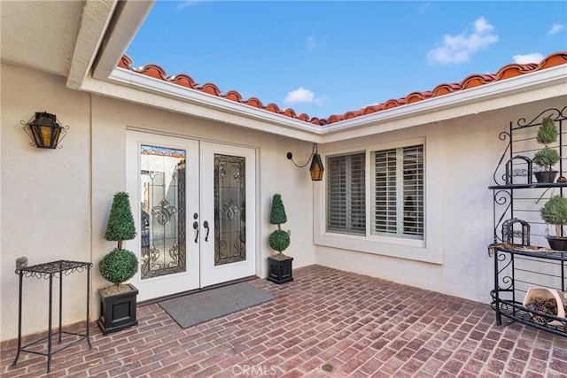 doorway to property featuring a patio area and french doors