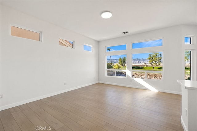 spare room featuring light hardwood / wood-style flooring