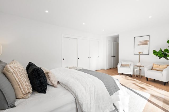 bedroom with a closet and light hardwood / wood-style flooring