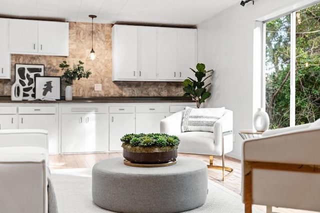 kitchen featuring white cabinetry, pendant lighting, and tasteful backsplash