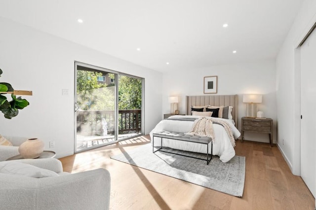 bedroom with light hardwood / wood-style flooring and access to outside