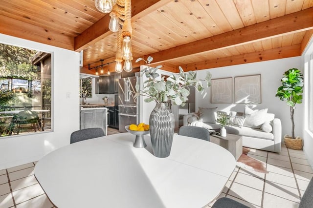 dining space with wooden ceiling, light tile patterned floors, and beam ceiling