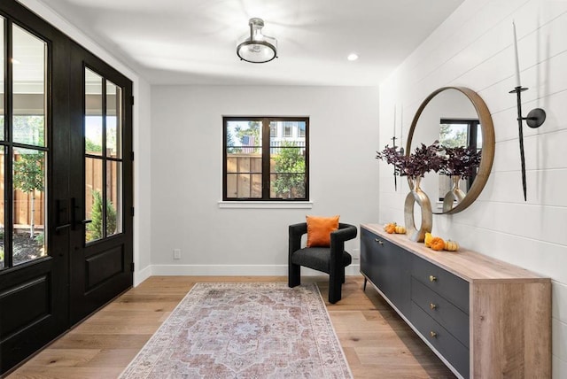 entrance foyer featuring light hardwood / wood-style floors and french doors