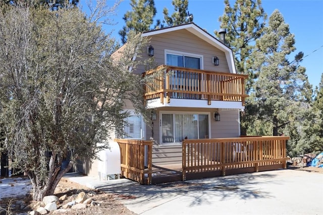 rear view of property featuring a balcony