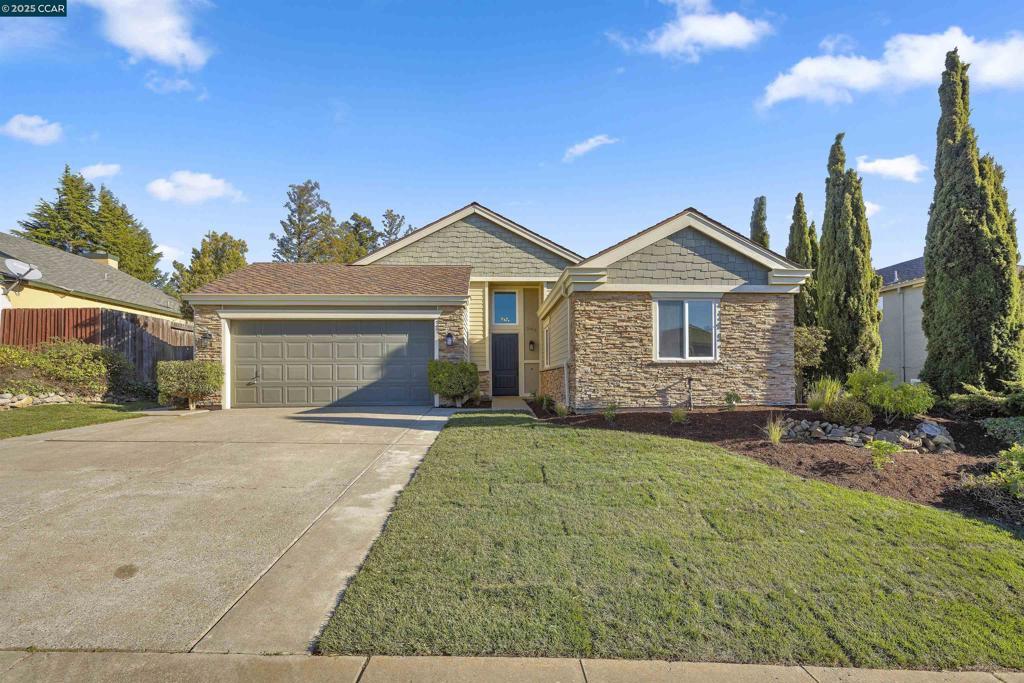 ranch-style house with a front yard and a garage