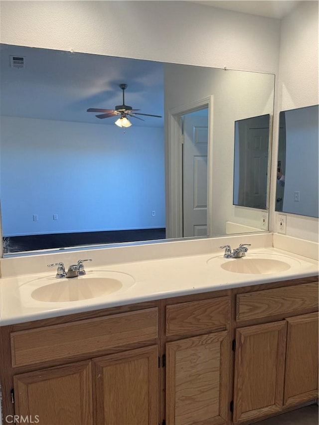 bathroom featuring ceiling fan and vanity