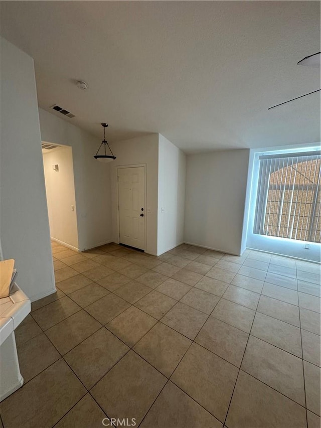 empty room with light tile patterned floors