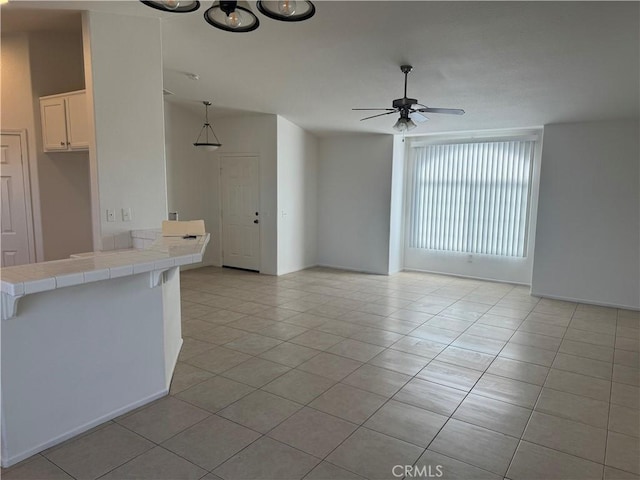 interior space featuring ceiling fan and light tile patterned flooring