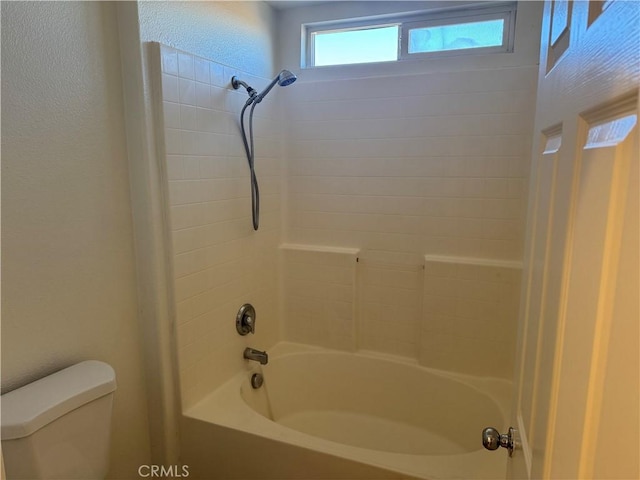 bathroom with toilet and shower / washtub combination