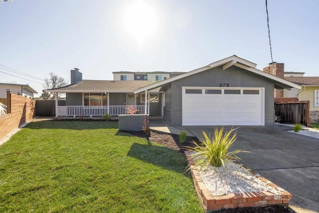 view of front of house featuring a garage, a front yard, and a porch