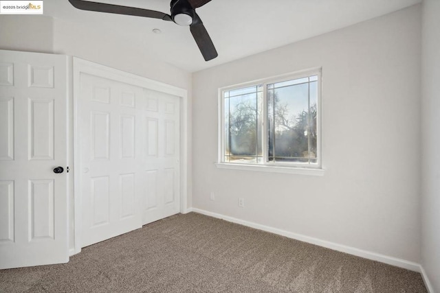 unfurnished bedroom with a closet, ceiling fan, and carpet flooring