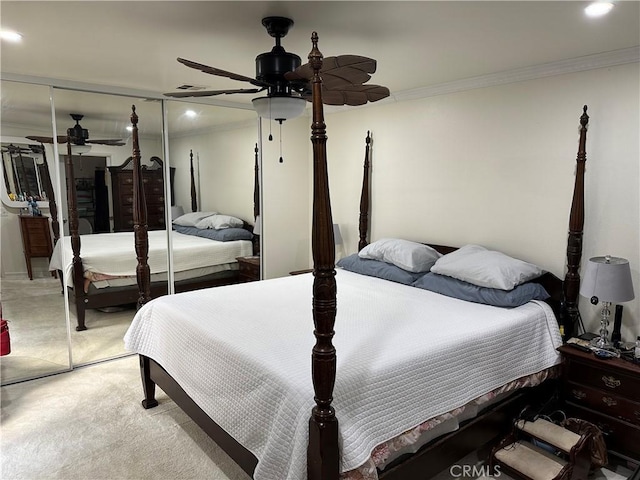 bedroom featuring ornamental molding, light carpet, and a closet