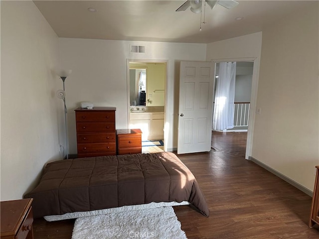 bedroom with dark hardwood / wood-style floors