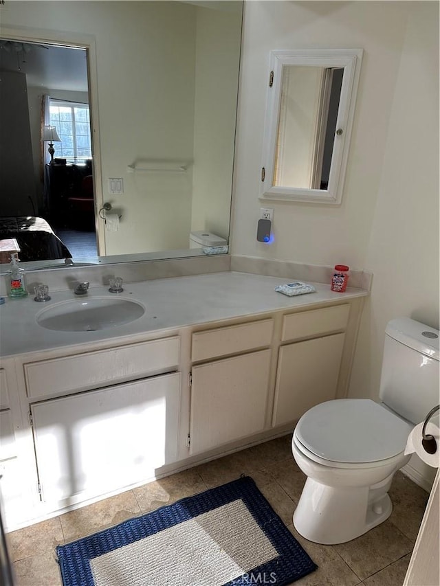 bathroom with vanity, tile patterned flooring, and toilet