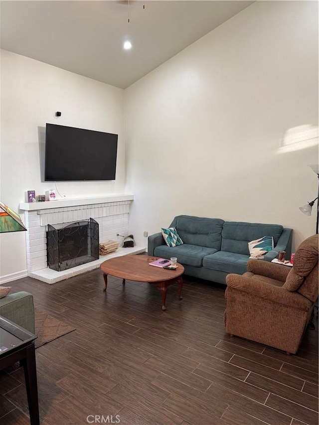 living room with a fireplace and dark hardwood / wood-style flooring