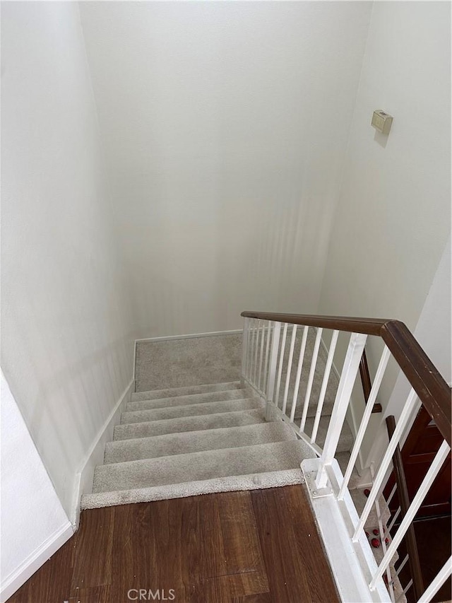 staircase with wood-type flooring