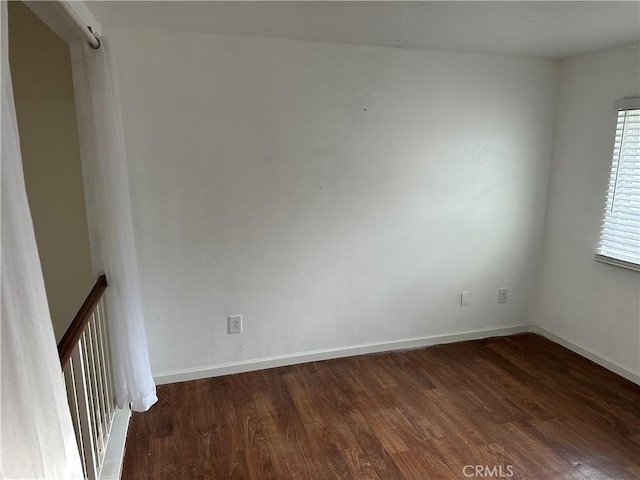 unfurnished room featuring dark hardwood / wood-style flooring