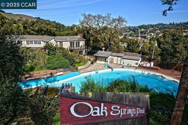 view of pool with an outbuilding