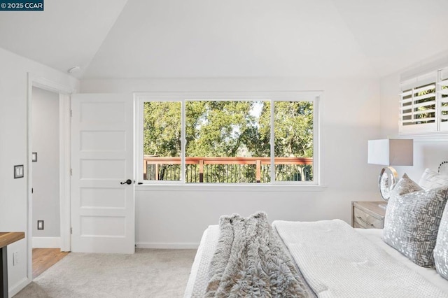 carpeted bedroom featuring lofted ceiling