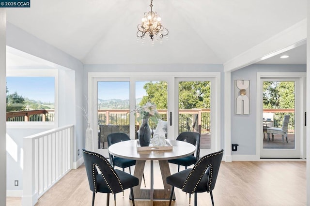 sunroom featuring vaulted ceiling, a wealth of natural light, and a chandelier