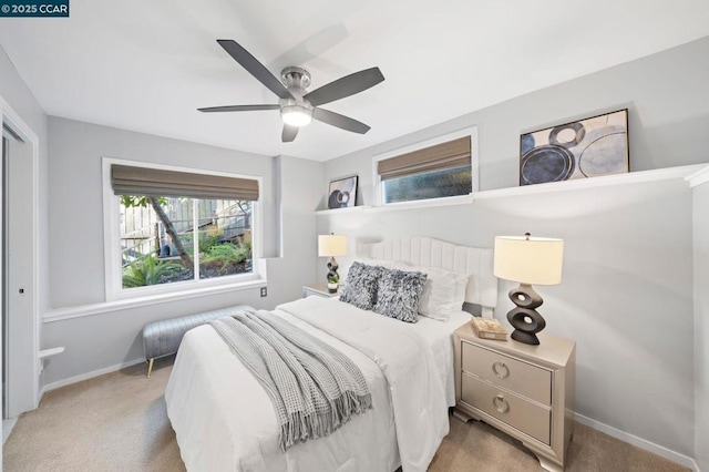 bedroom with ceiling fan and light colored carpet