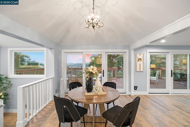 dining space featuring light hardwood / wood-style flooring and a notable chandelier