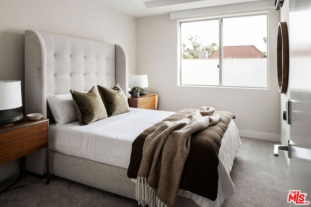 carpeted bedroom with stainless steel refrigerator