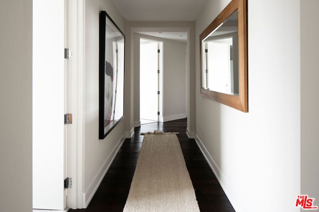 corridor featuring dark wood-type flooring