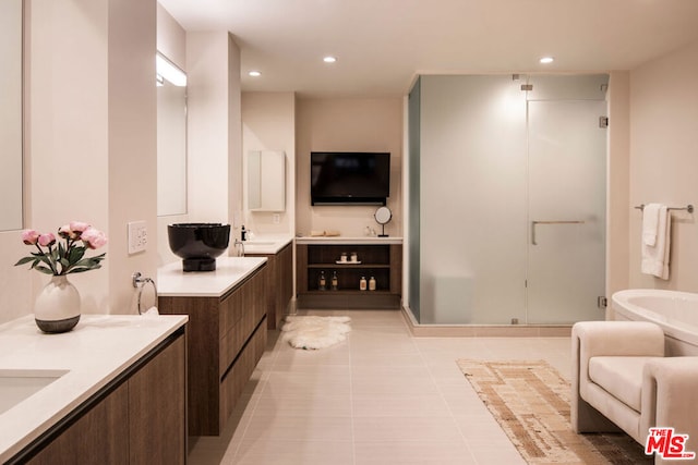 bathroom featuring a shower with door, vanity, and tile patterned flooring