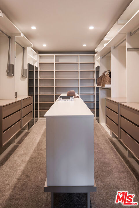 spacious closet featuring dark carpet